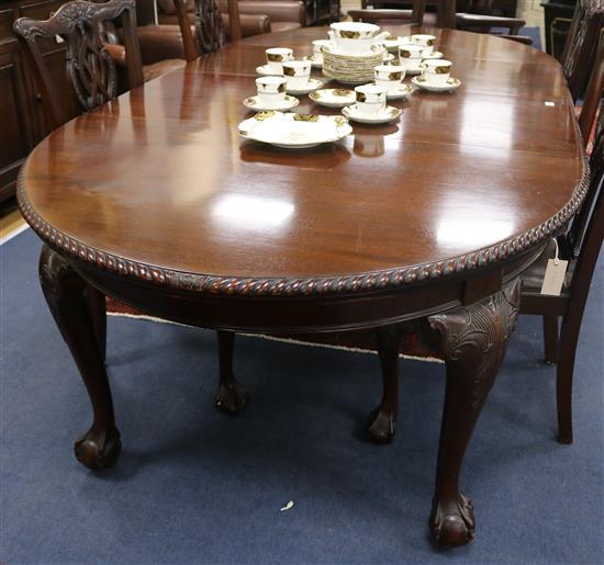 A Chippendale design mahogany oval topped extending dining table, with two spare leaves, W.122cm